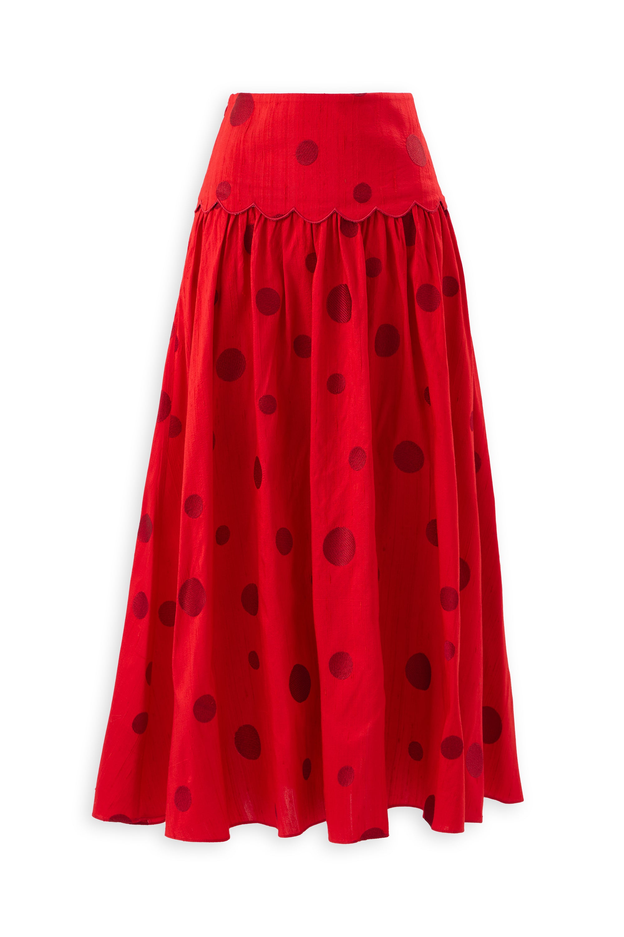 The POLKA FLAME SKIRT is a long red silk shantung skirt with a flared silhouette, featuring large and small dark red polka dot embroidery and a scalloped waistband.