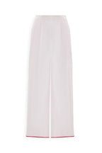 SCARLET PANTS: High-waisted, wide-leg cotton pants with a front seam and a touch of red trim at the hem, shown on a white background.